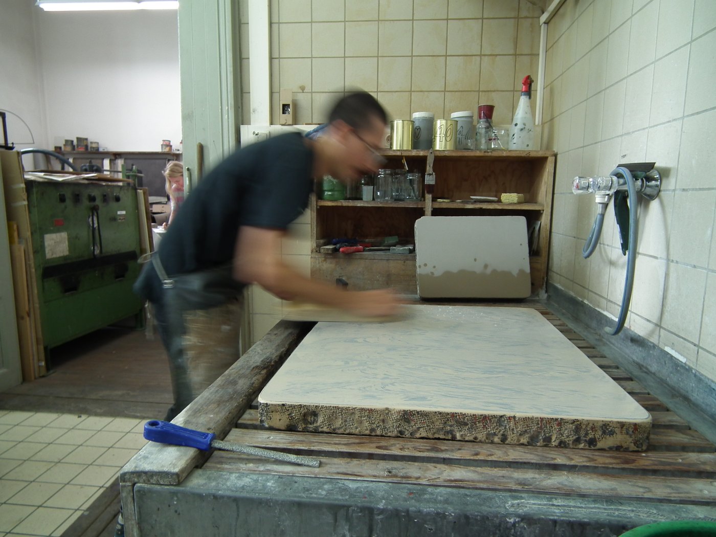 One person works the lithographic stone