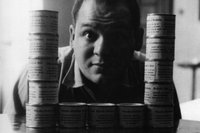 Piero Manzoni with some cans of Merda d’artista (Artist’s Shit) in his apartment on Via Cernaia, Milan, 1961 © Fondazione Piero Manzoni, Milan