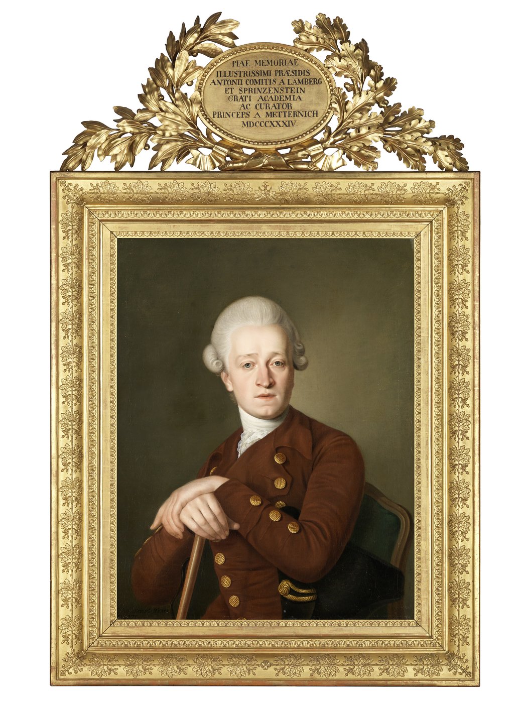 This portrait, stretched in a large, sumptuous gilt frame, shows Count Lamberg-Spritzenstein. The count is portrayed in a seated position from the waist up. His hands rest crossed on a walking stick in front of his chest. His head is turned towards the viewers. The count is depicted with very fair skin and wears a baroque, white-powdered wig with the hair combed strictly back and coiffed in curls on the sides. He wears a brown jacket with a large collar and two rows of round golden buttons. The same buttons are also on the sleeves. Around his neck, the count wears a white frilled collar tucked into his jacket. Under his right arm he holds a black historical tricorn hat. He appears to be sitting in front of an olive green wall. The picture is painted in a realistic style with clear lines. The count looks young, about 30 to 35 years old. His facial expression is serious.