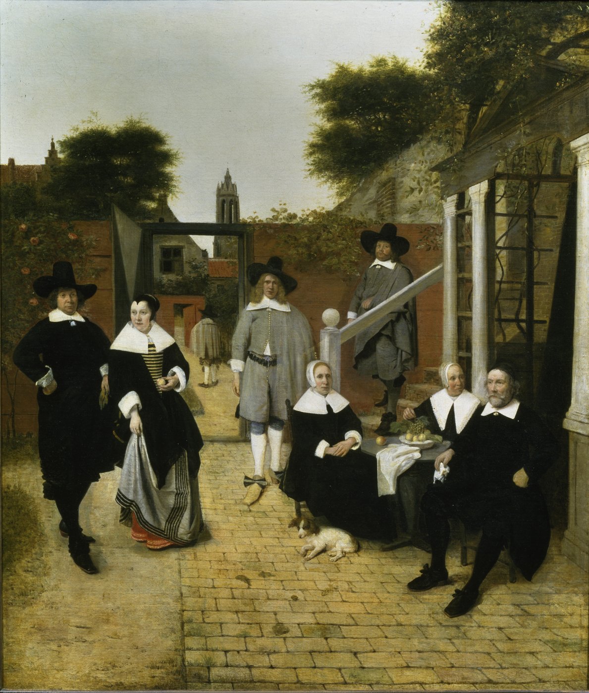 The painting is a depiction of a family grouped in a courtyard. The family members take different positions and postures. The younger ones are spread out in the courtyard, while the older ones are sitting together at a table. The portrayed people appear rigid and staged. Their stern postures reflect the straight lines of the courtyard walls and the architecture in the middle and background. All wear black or grey robes with large white collars and headdresses. Through the courtyard door, the view can glide backwards to a church tower. Every brushstroke seems to be thought out and controlled in order to reproduce the perspective, the architecture as well as the figures as realistic as possible.
