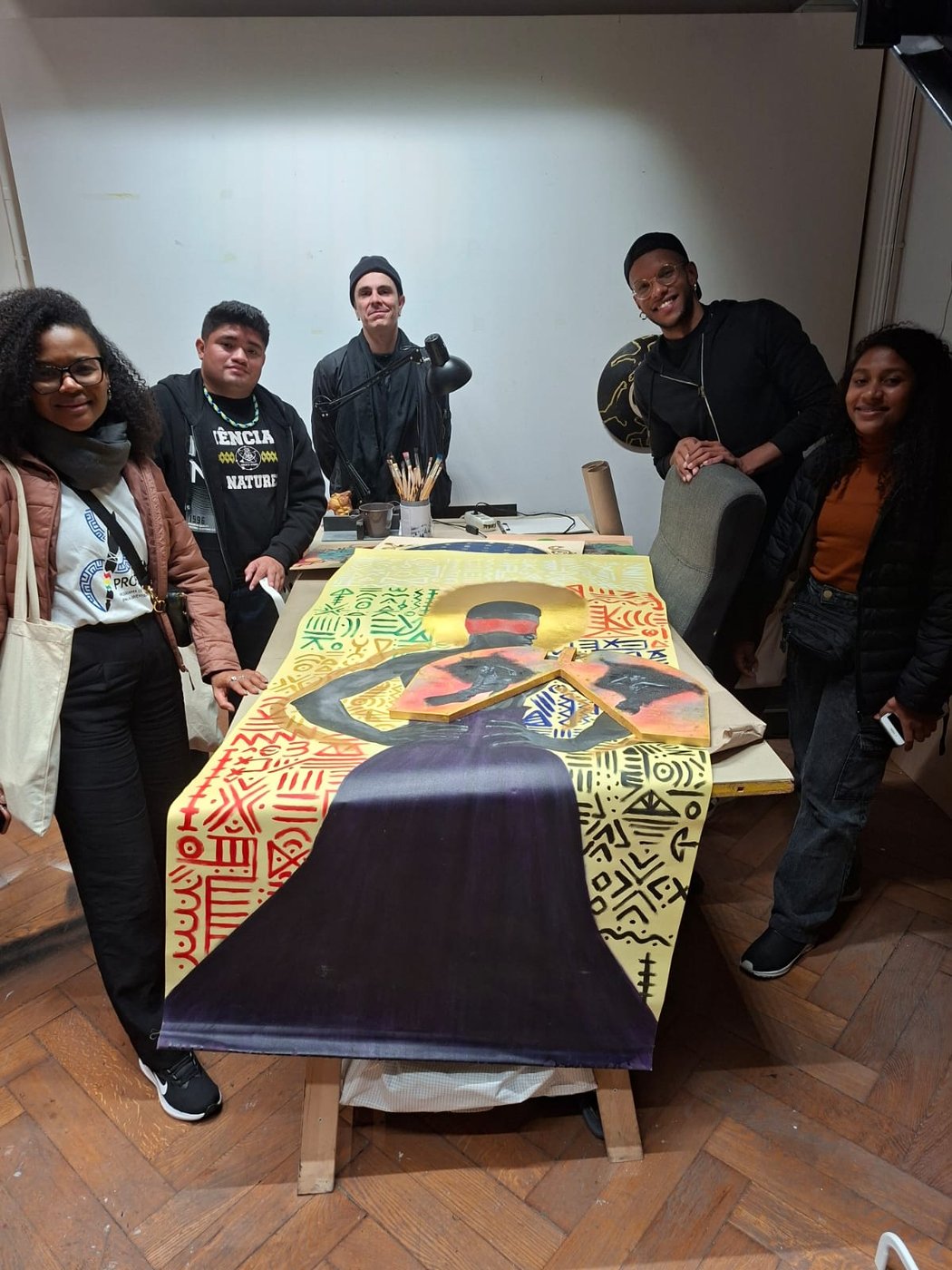 Studierende stehen um einen Tisch, ein gedrucktes Werkstück liegt auf dem Tisch.