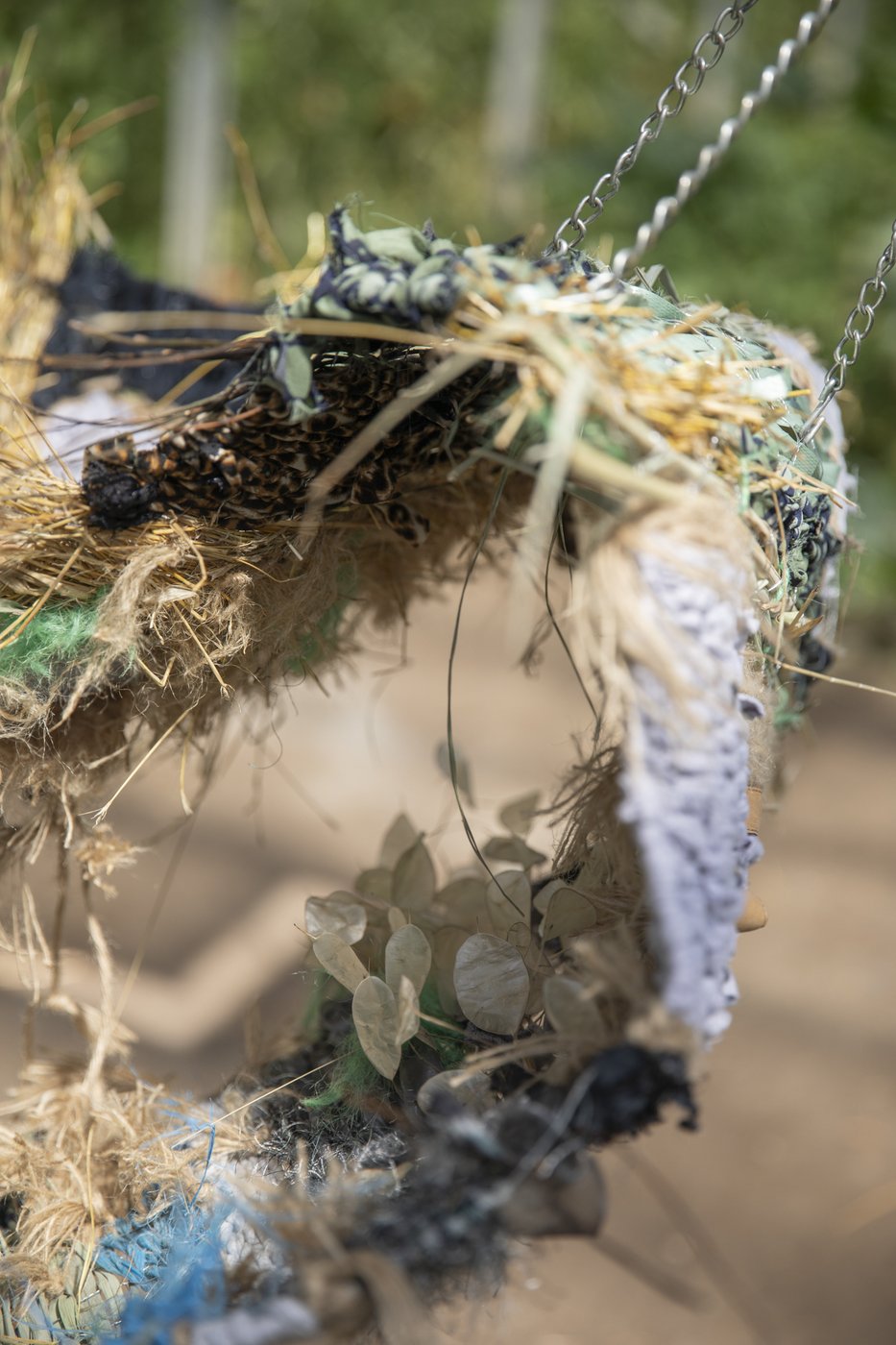 Pille-Riin Jaik, proposal for landscape (a nonorientable surface), collected clothes, garden hose, jute strings, plants from the Lobau area, plastic from the compost, chicken wire, belts, metal chains, 2025