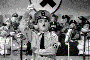 black and white filmstill of the movie "the great dictator" from Charlie Chaplin,where he is dressed up as Adolf Hitler