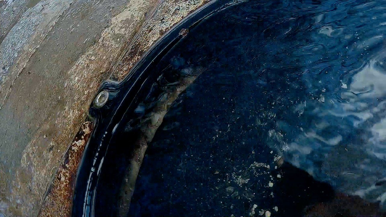Gassi by Johannes Lehnen and Nora Ludwig. AUT 2021, color, 4 min photo of a water varnish reflecting the light, next to stone floor