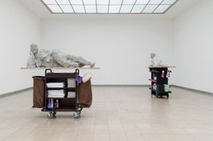 Nicole Wermers classically appealing female nudes lie on cleaning carts like those used in hotels.