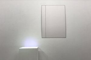 Picture of a white tablet on a white wall