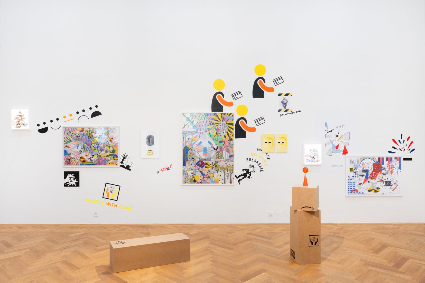 View of an exhibition room with paintings and installations