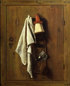 a brown wooden door with a white towel, a brush and other tools