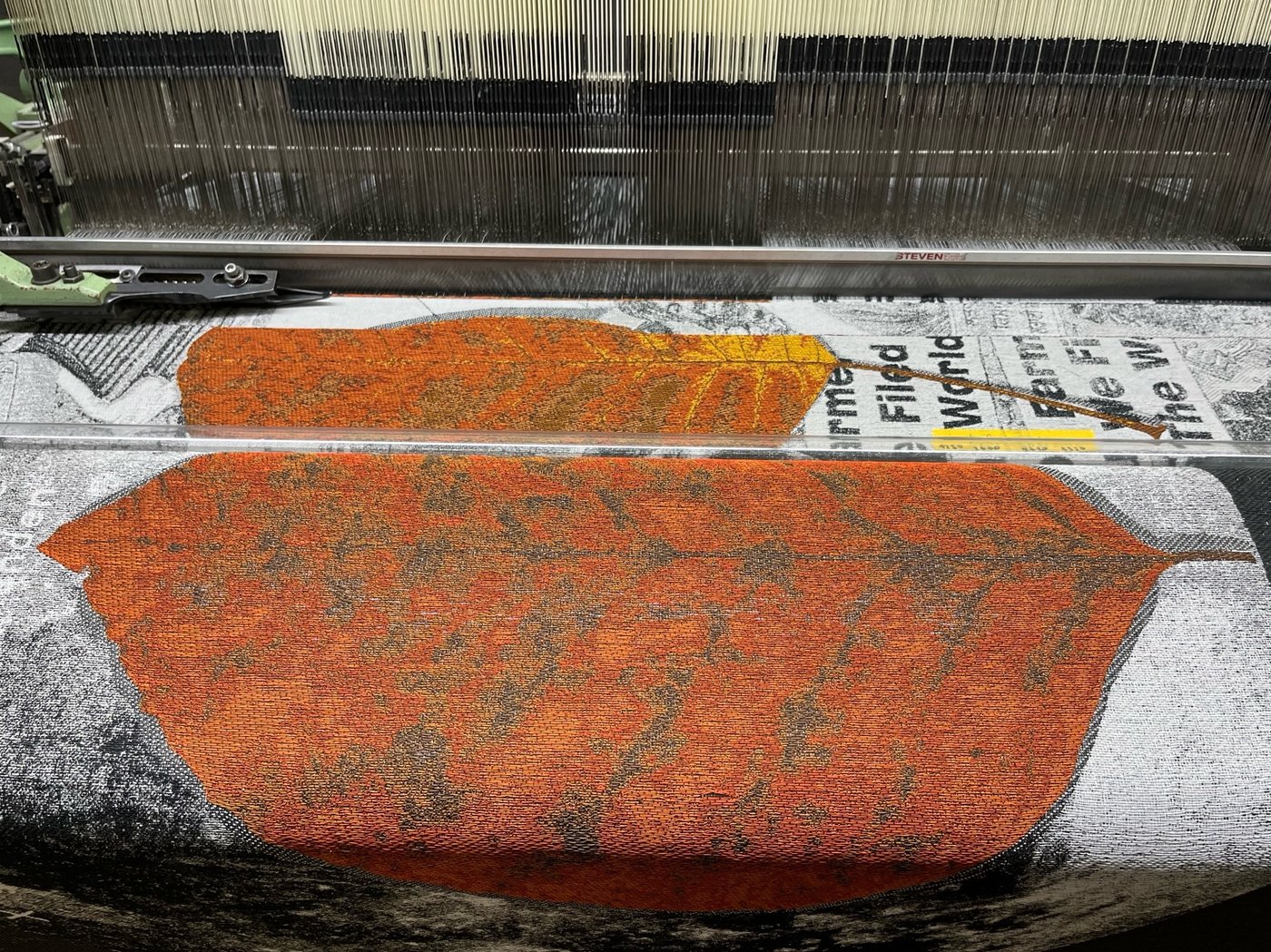 orange leave on a black and white background on a jacquard loom