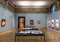 exhibition space with oil paintings on the wall and other art objects