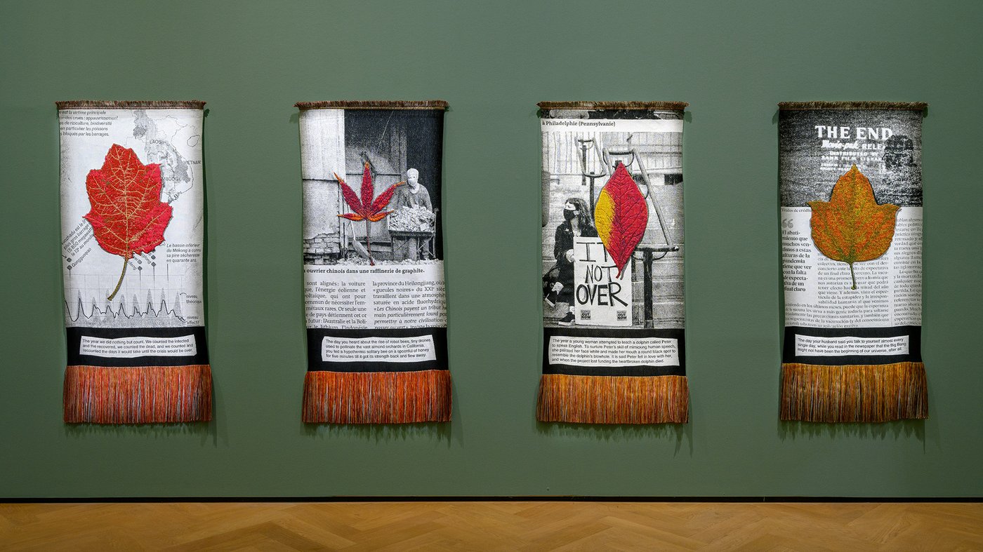 a few carpets with text on a green wall