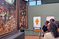 people watch a colorful oil painting by bosch