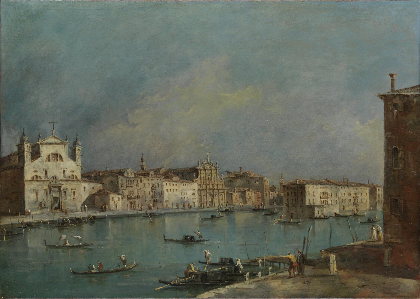 a few boats on a canal in the water before houses