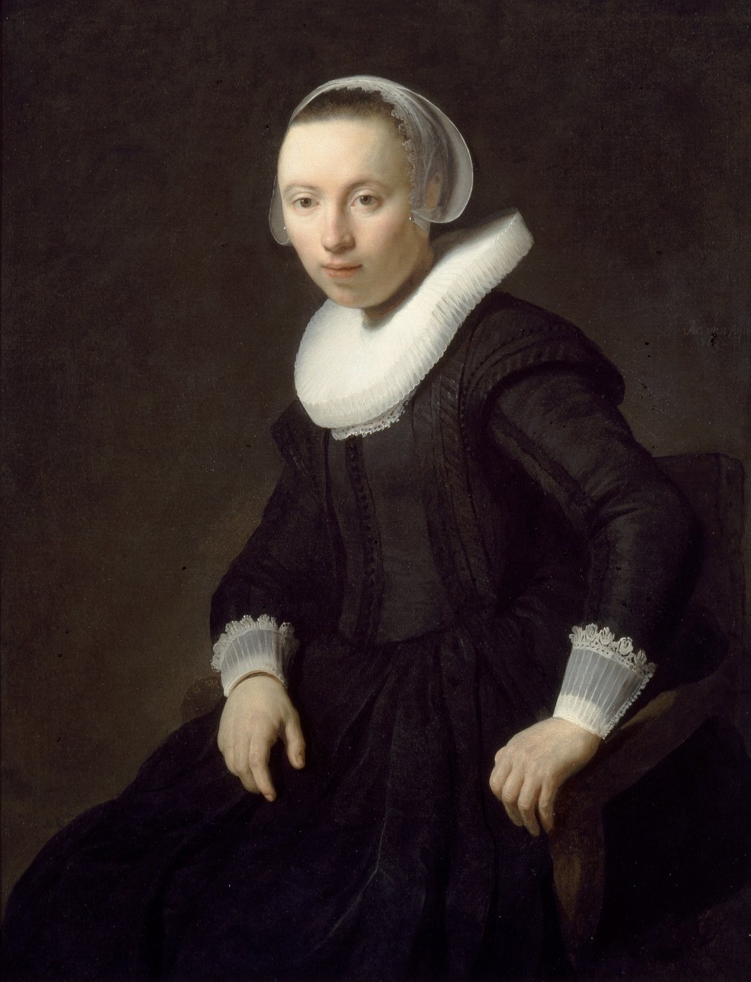A historical portrait painting of woman in black dress with white fan collar and white headscarf and she is sitting on wooden chair.
