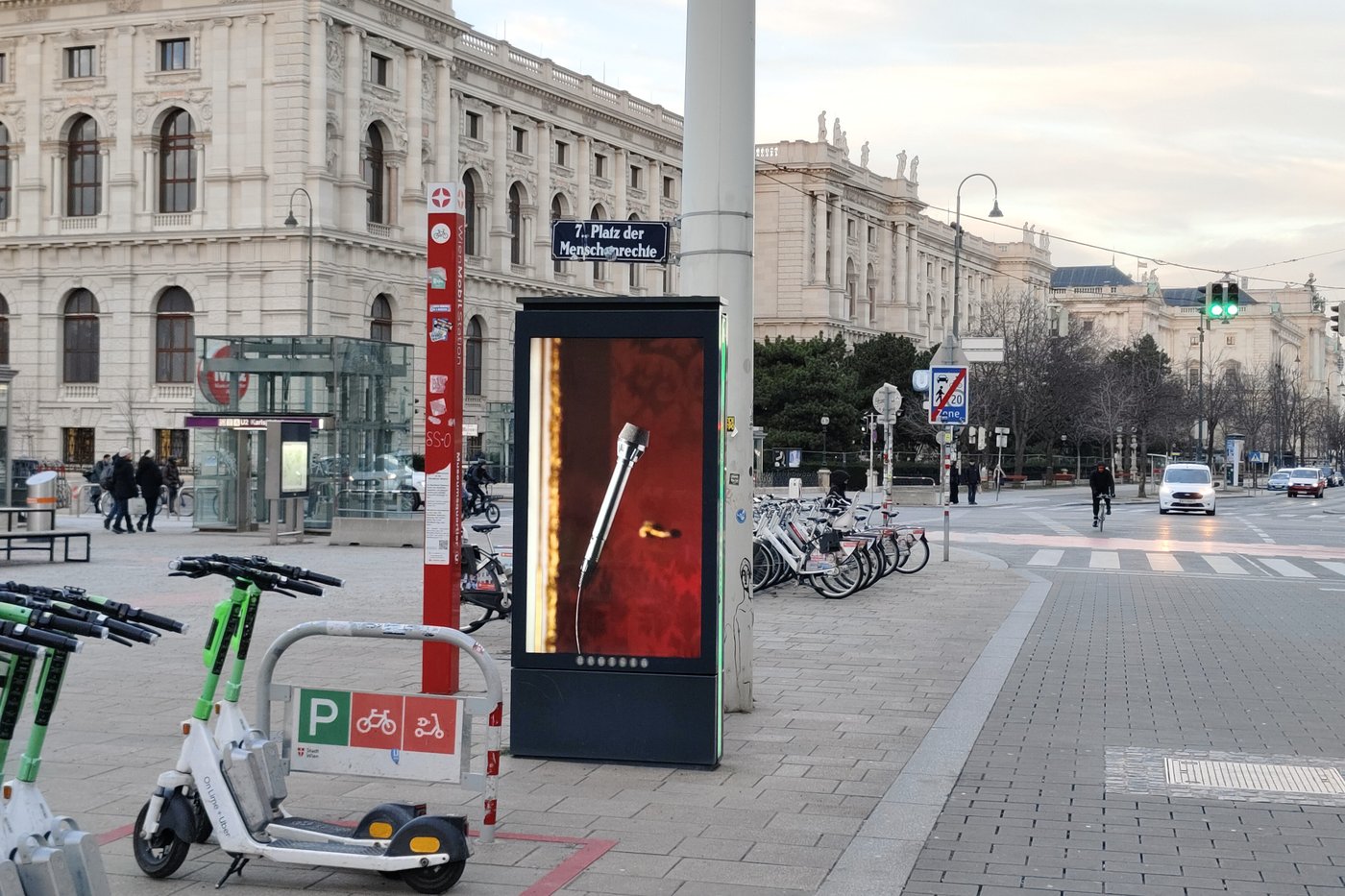 Screen on a street with houses in the background