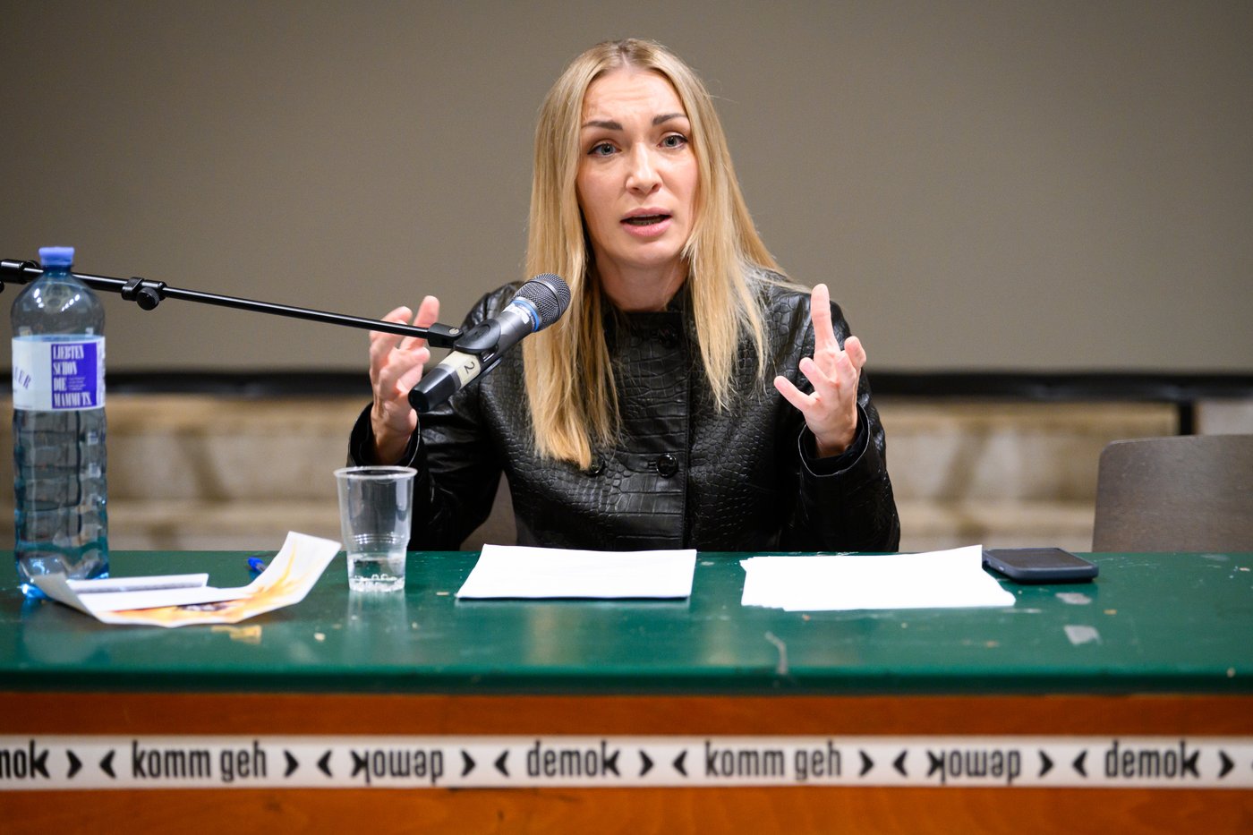 a woman is speaking on stage