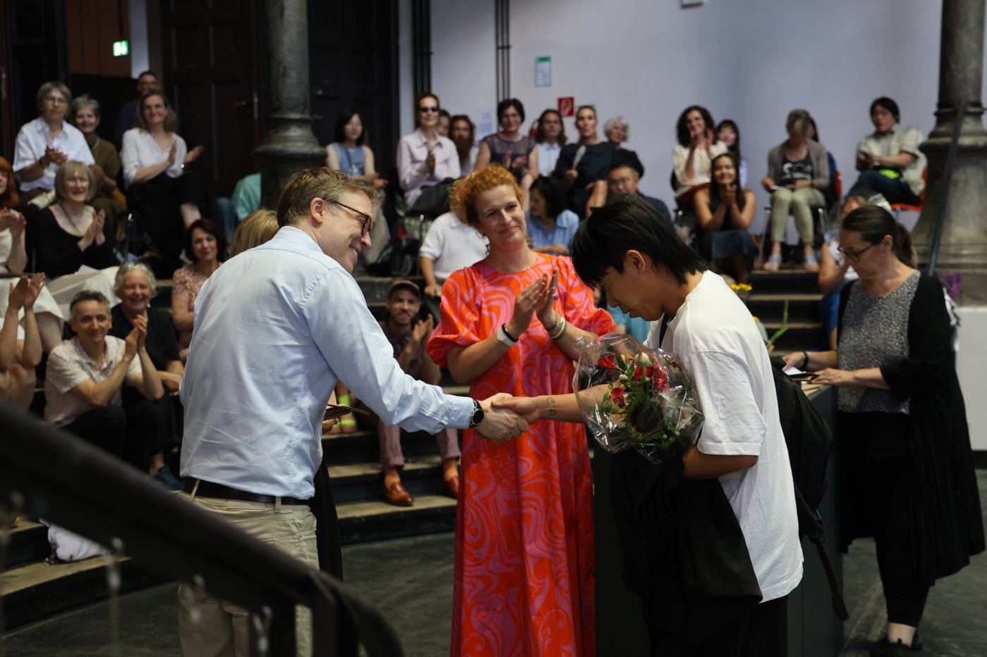 honoring the award winner with flowers and a diploma