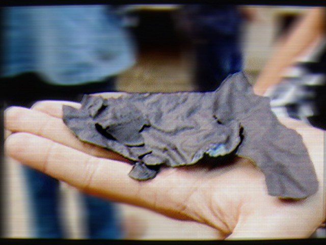 An extended flat hand with ash on its palm.