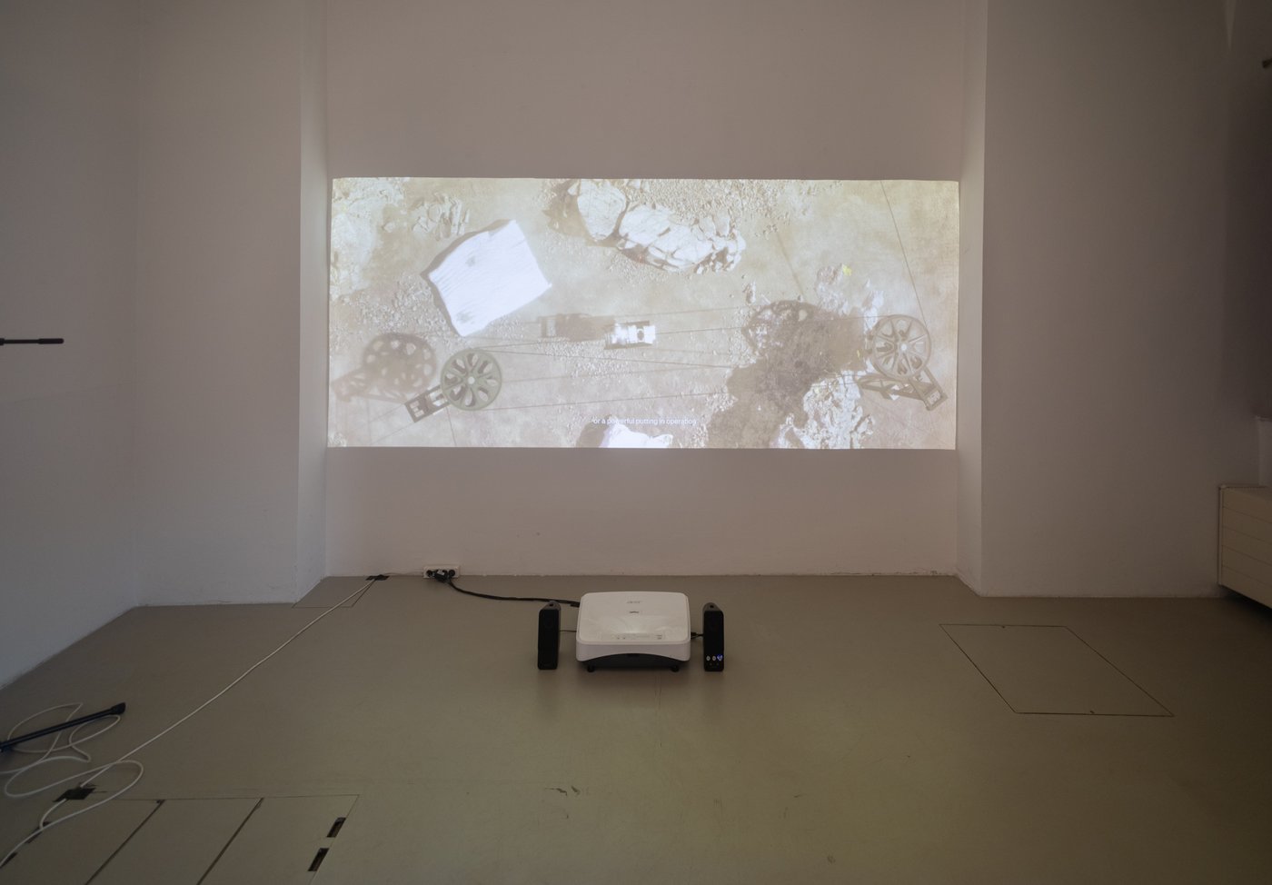 Screen on a wall in an empty exhibiton room