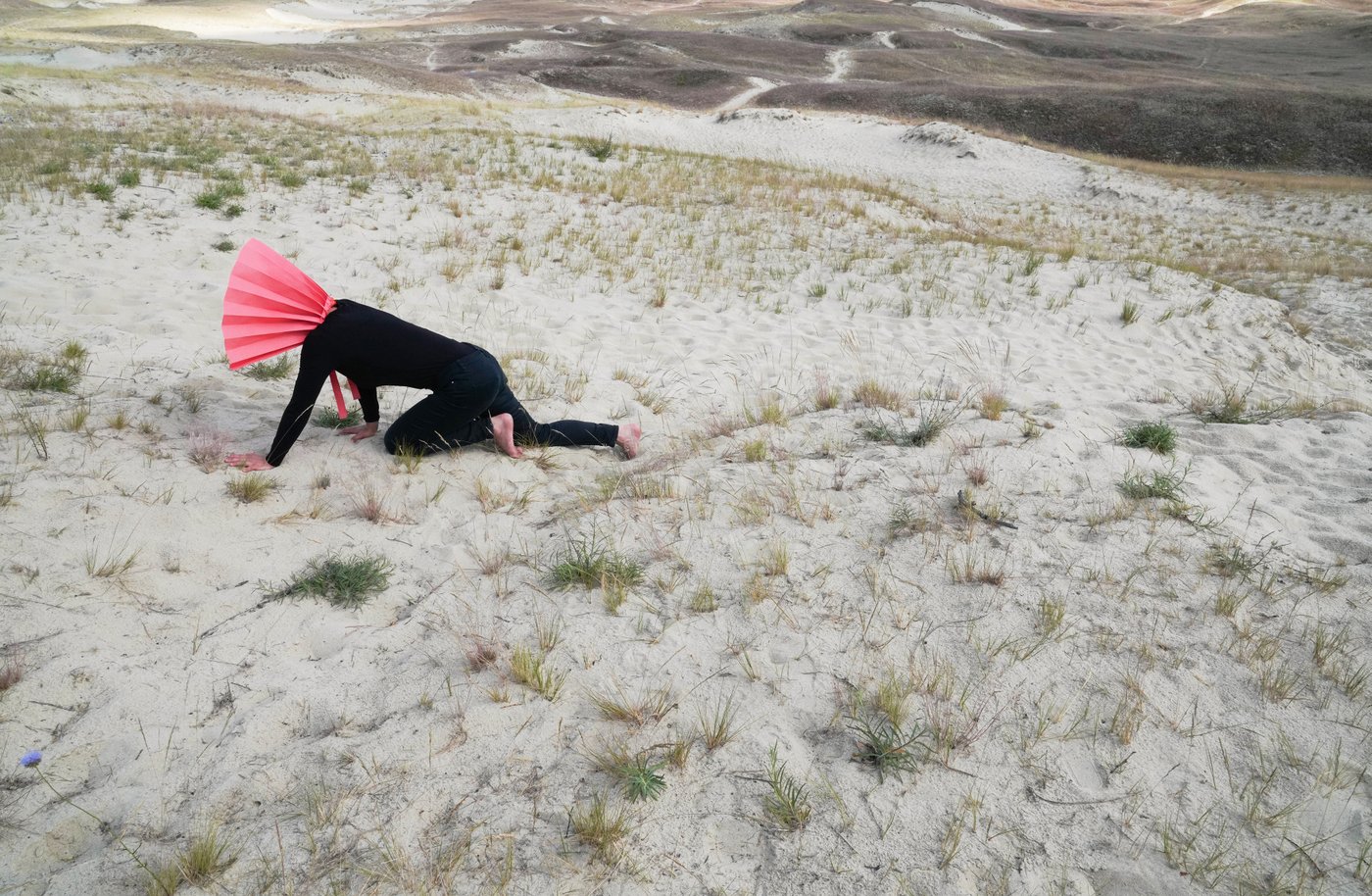 Person crawling on the ground of a desert